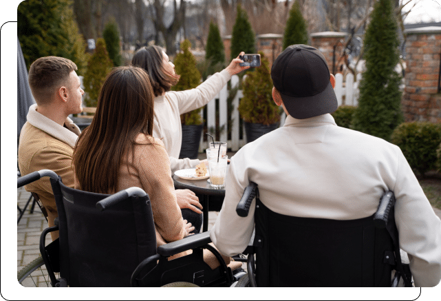 Group of friends taking a selfie while sitting at an outdoor café.