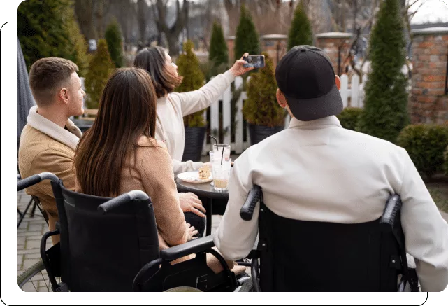 Group of friends taking a selfie while sitting at an outdoor café.